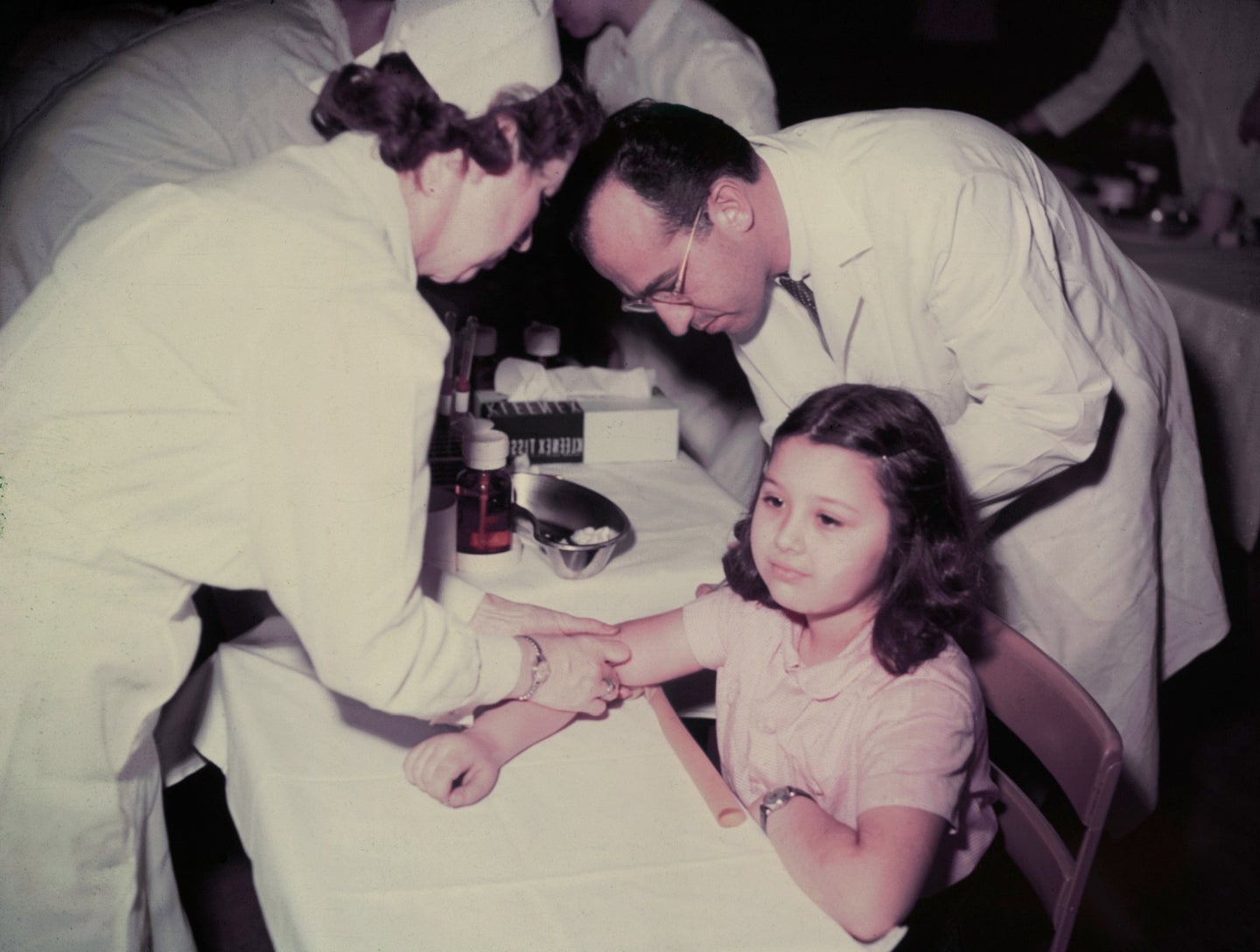 At right, Jonas Salk, the doctor behind the first polio vaccine, administers a shot to a kid in Pennsylvania in 1955.
