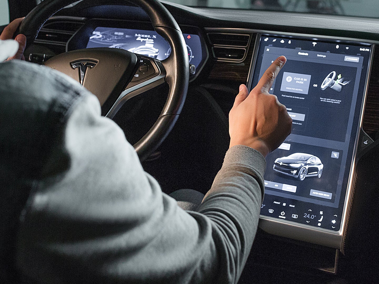 Man using Tesla interface inside vehicle