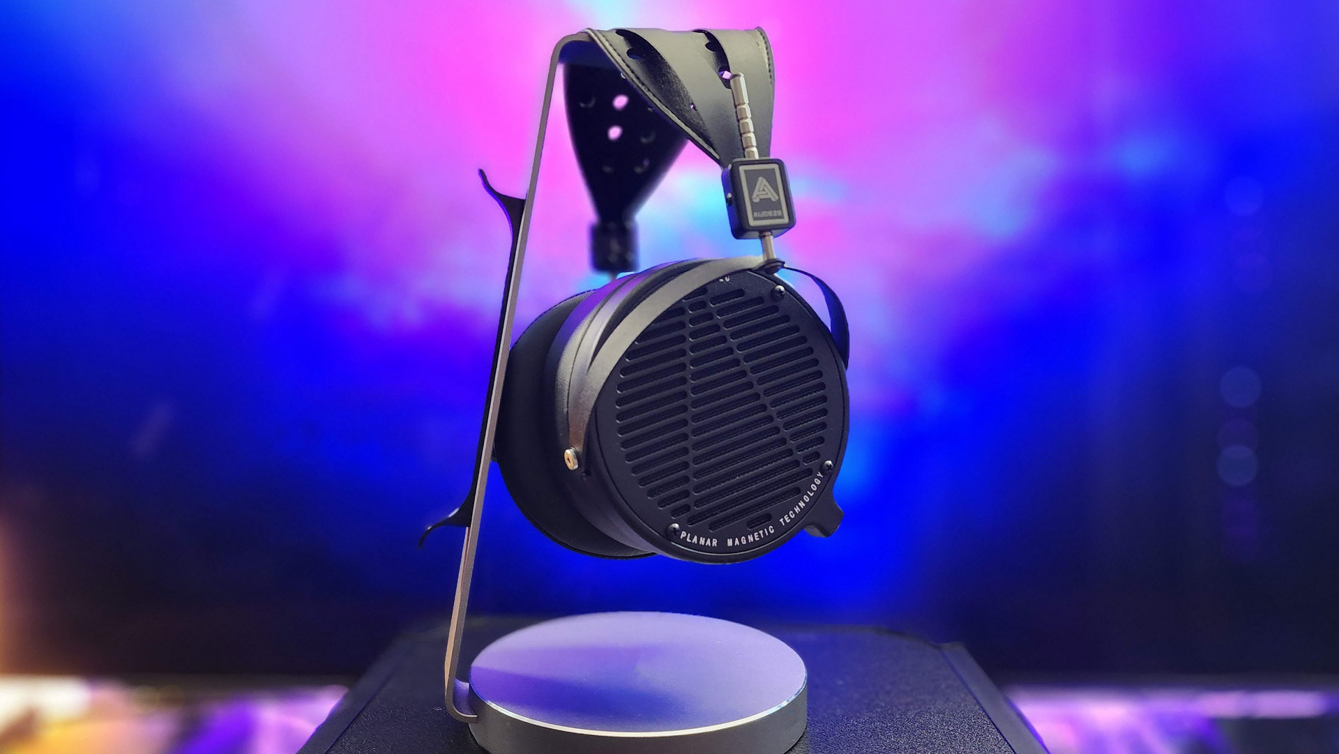 Audeze LCD-2 planar-magnetic headphones on a stand against a purple background
