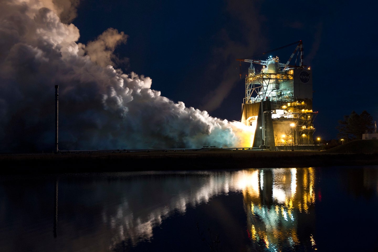 NASA SLS rocket engine test at Kennedy Space Center at night