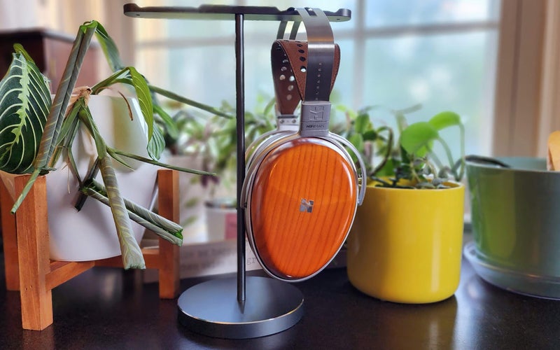 The HIFIMAN Audivina planar magnetic headphones on a stand in front of potted plants