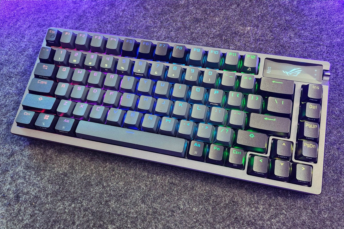 ASUS ROG Azoth wireless mechanical keyboard on a counter with purple light