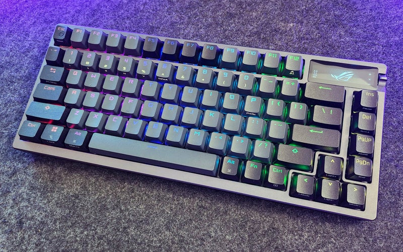 ASUS ROG Azoth wireless mechanical keyboard on a counter with purple light