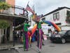 Bourbon Street, New Orleans monkeypox vaccine clinic with clowns on stilts and Pride flags waving