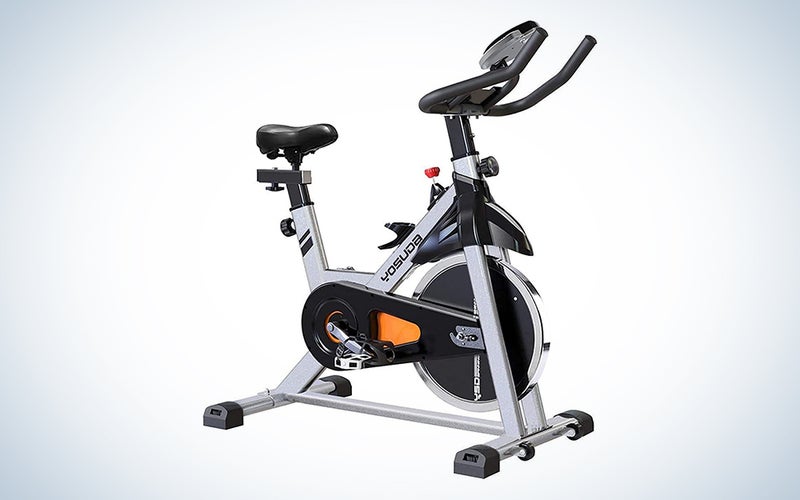 A Peloton-like spin bike on a blue and white gradient background