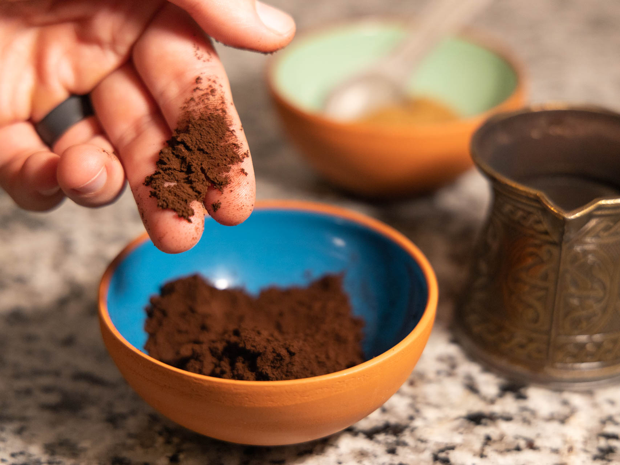 hands taking coffee grounds