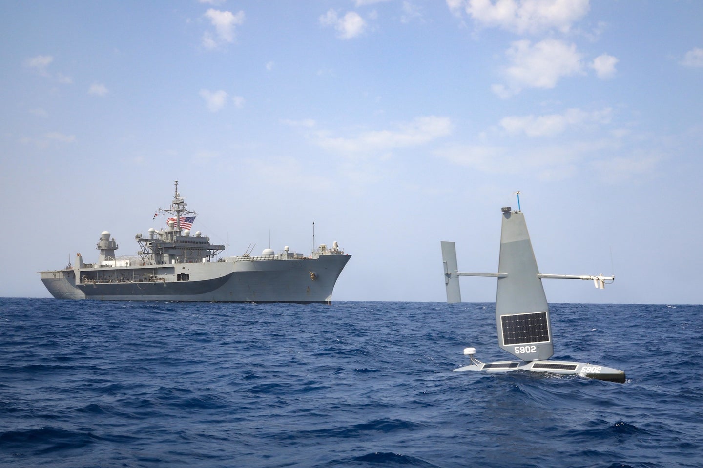 A Saildrone in the Red Sea in April, with the USS Mount Whitney in the background.