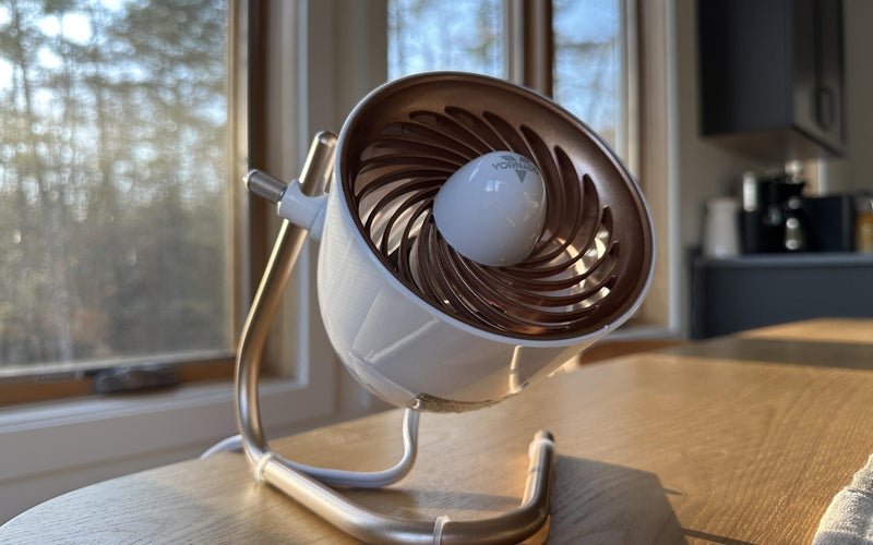 white and gold Vornado Pivot Personal Air Circulator Fan on a wooden table