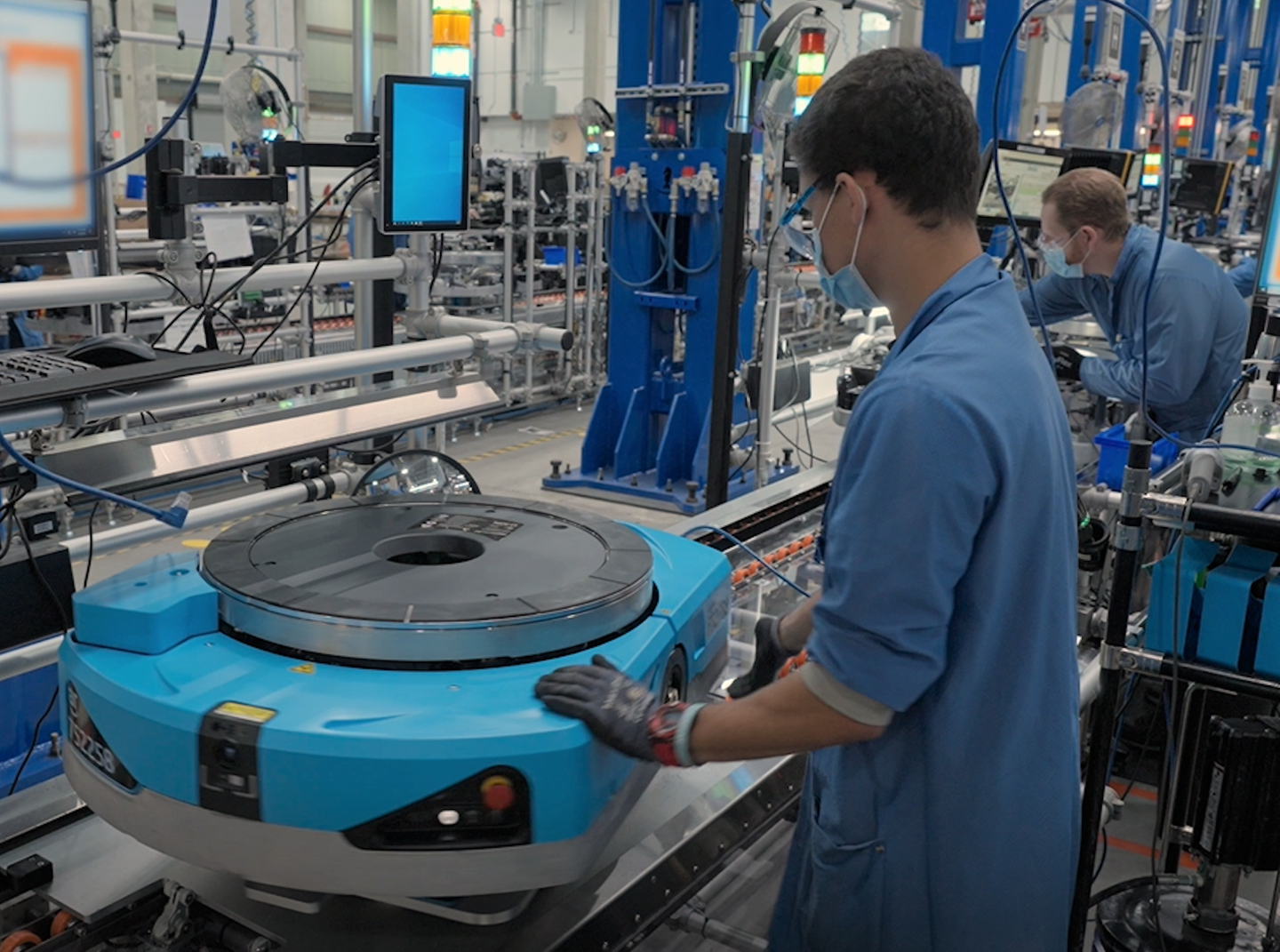 Amazon robotics working working on assembly line