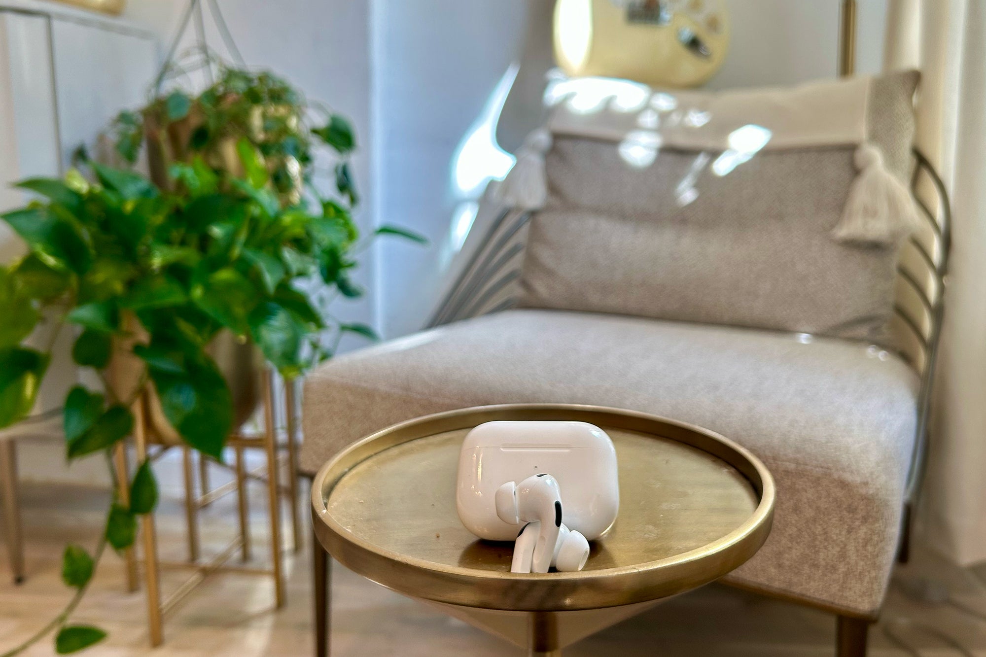 Apple AirPods Pro (2nd generation) on a gold pedestal