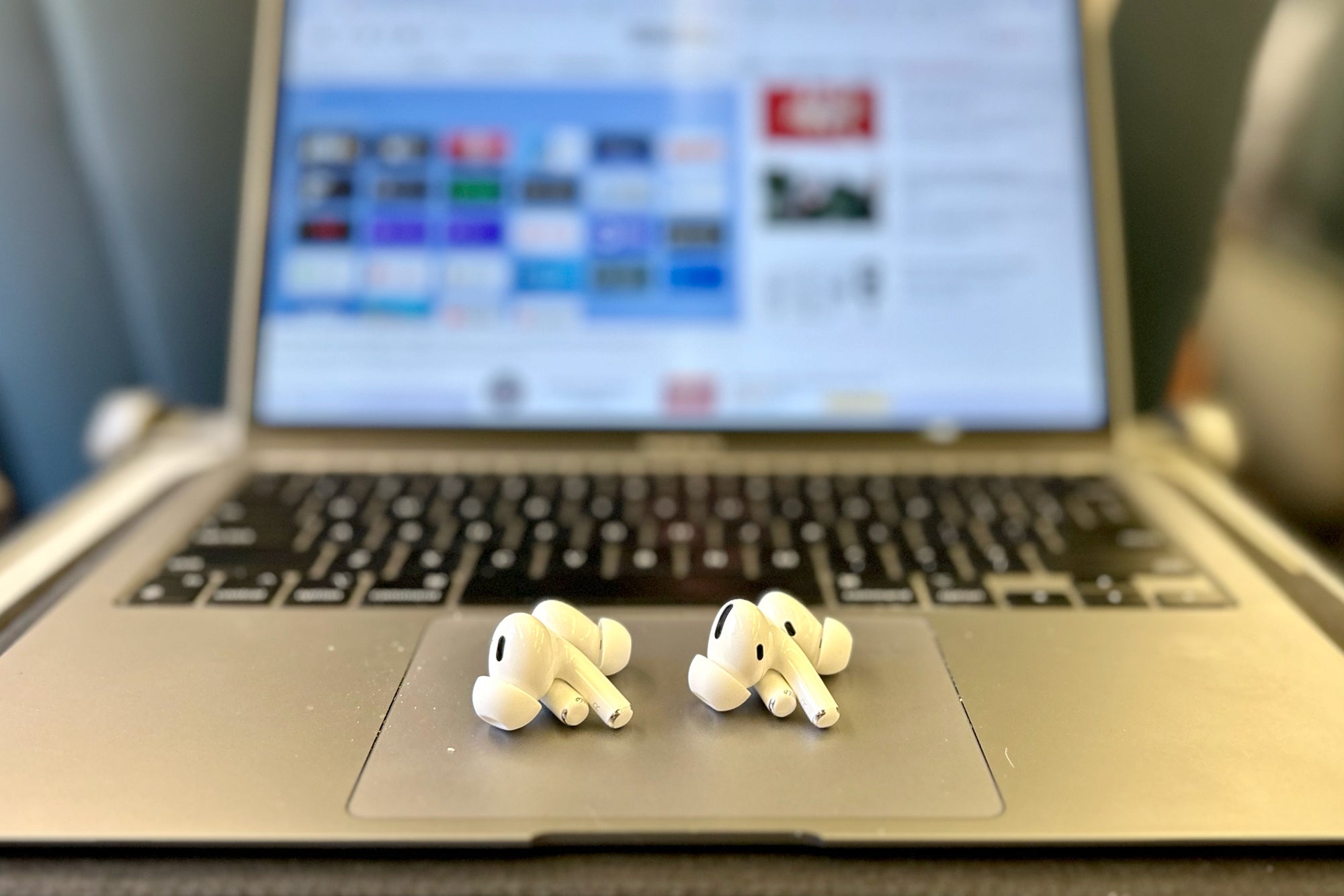 Apple AirPods Pro 1 & 2 side-by-side on a MacBook