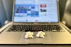 Apple AirPods Pro 1 & 2 side-by-side on a MacBook