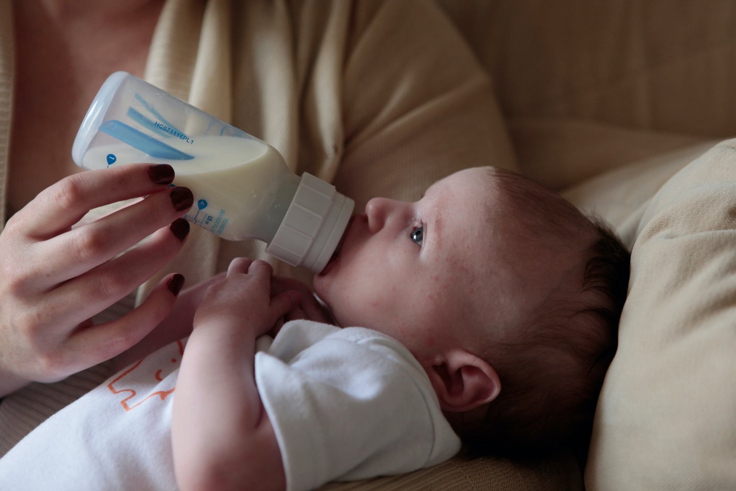 a baby feeds on a bottle