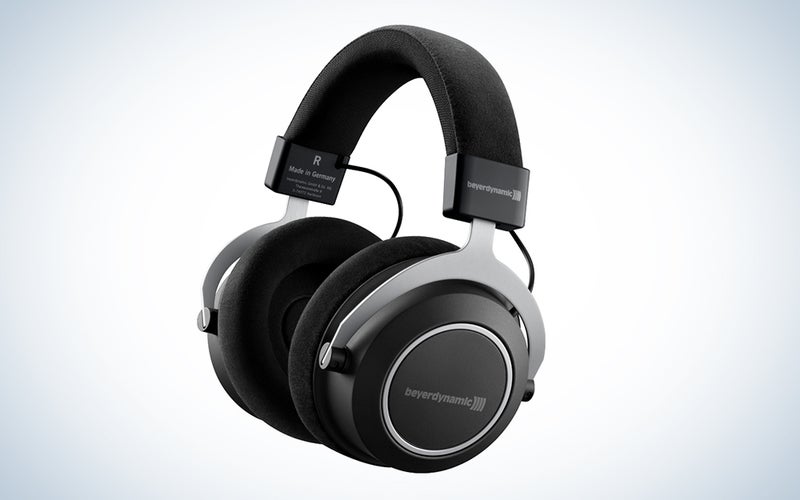 A pair of beyerdynamic Amiron Wireless headphones against a white and blue gradient background