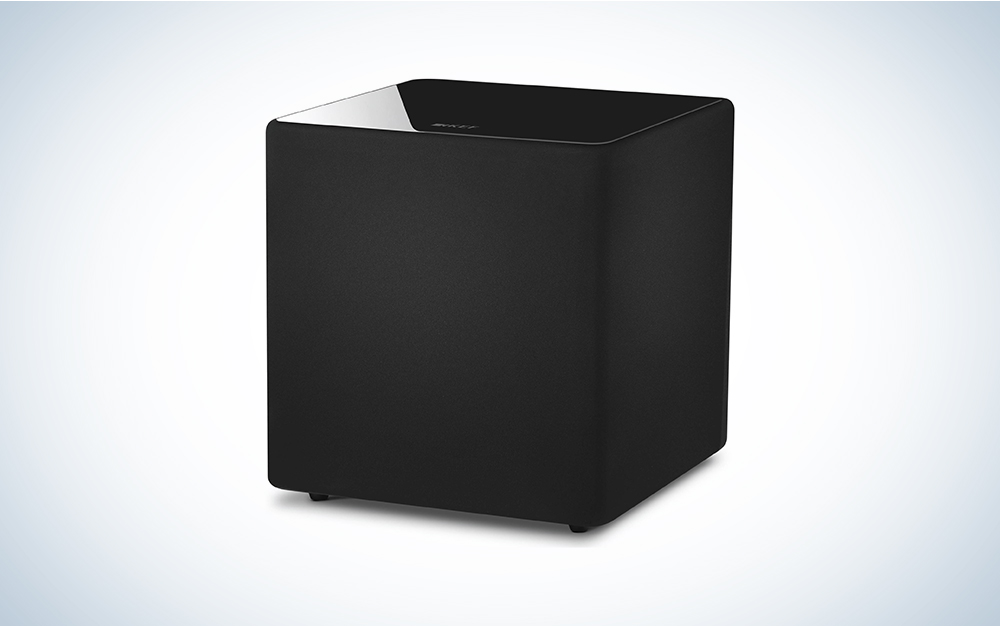 A black KEF Kube 10b on a white and blue gradient baclground