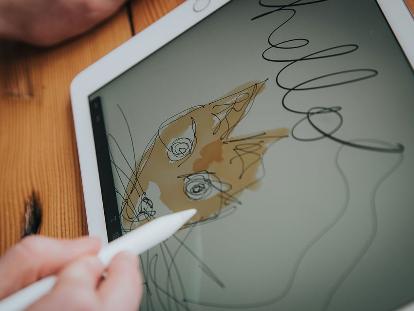 A young child drawing on an iPad using an Apple Pencil