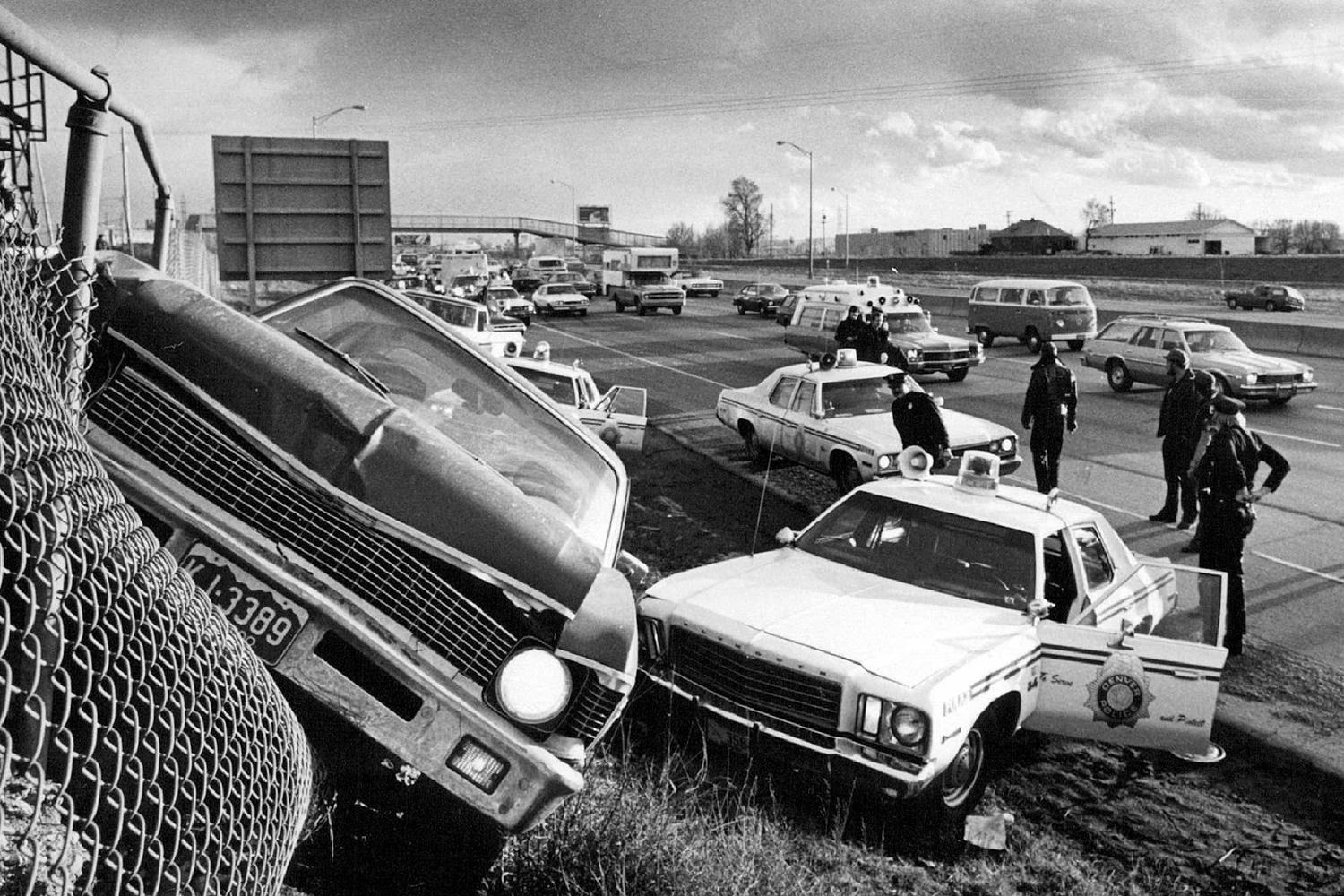 <b>1977:</b> High-speed chases rarely end well. This perp got his car caught in a chain-link fence along an Interstate 25 embankment in Colorado.