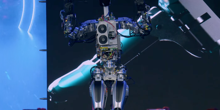 Tesla’s Optimus humanoid robot can shuffle across stage, ‘raise the roof’
