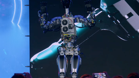 Tesla’s Optimus humanoid robot can shuffle across stage, ‘raise the roof’