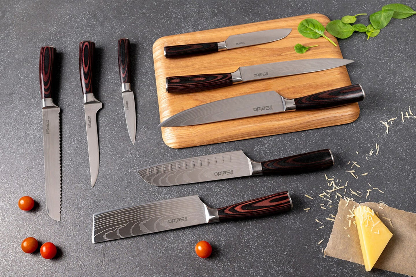 A set of Japanese cutting knives on a counter and cutting board.