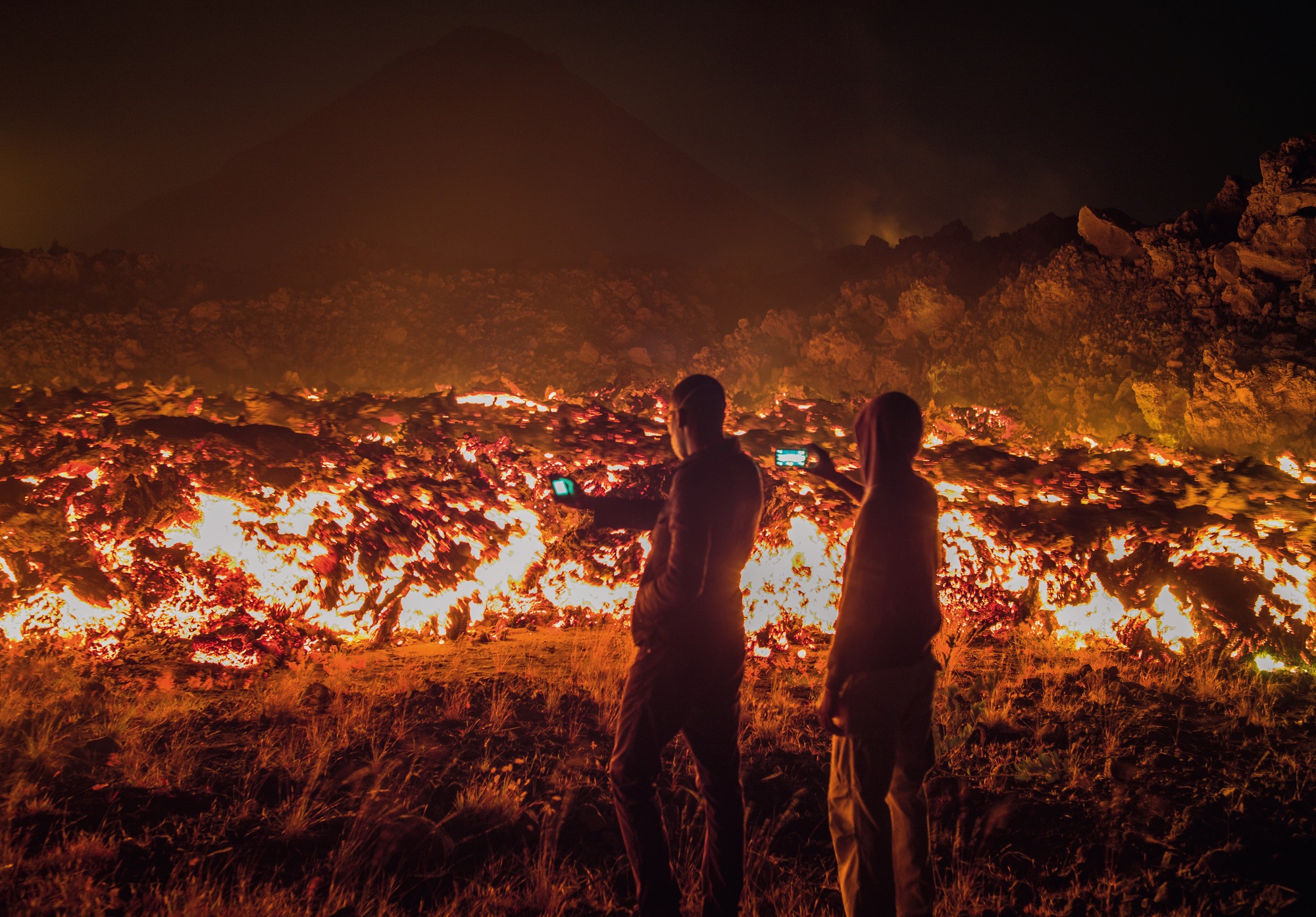 People taking photos of glowing lava on Cape Verde