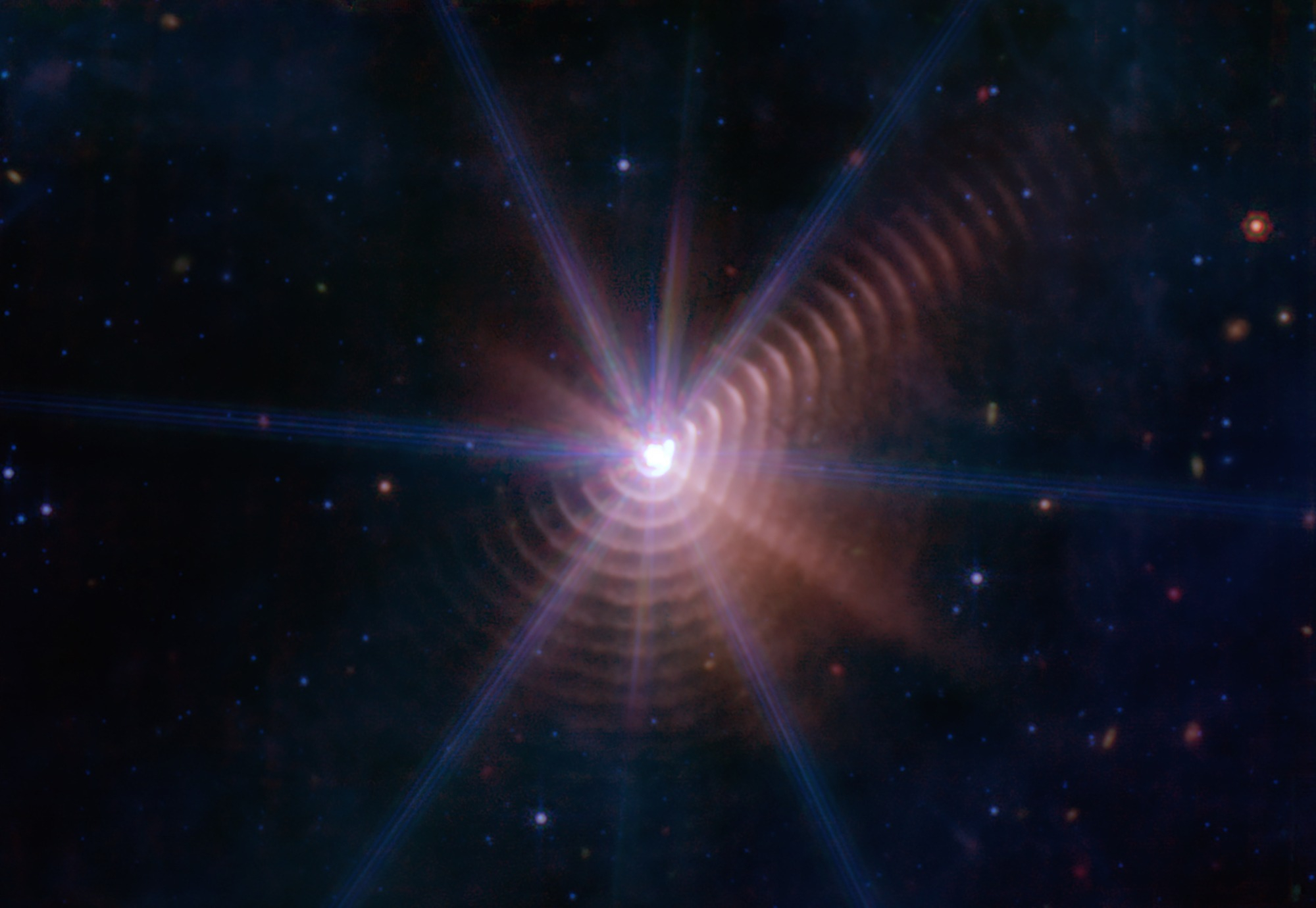 Image captured by the James Webb Space Telescope showing star binary WD140's concentric dust rings.