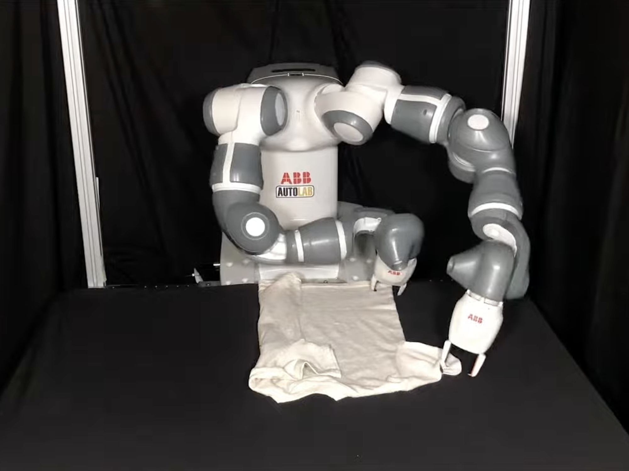 Two armed laundry folding robot folding a t-shirt