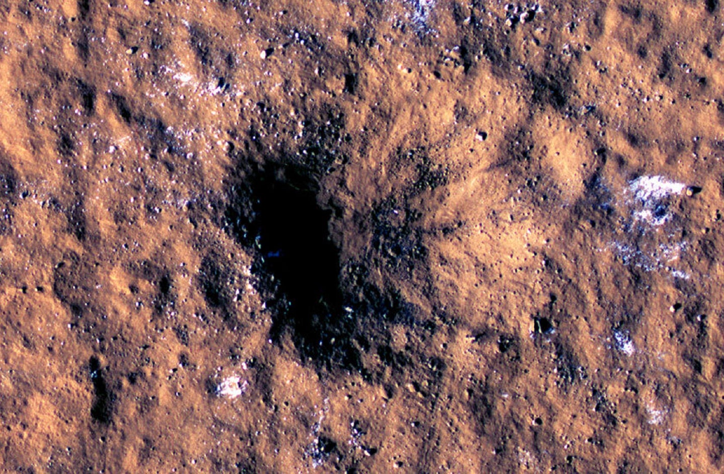 Mars surface impact crater from meteor strike with water ice captured by NASA instruments