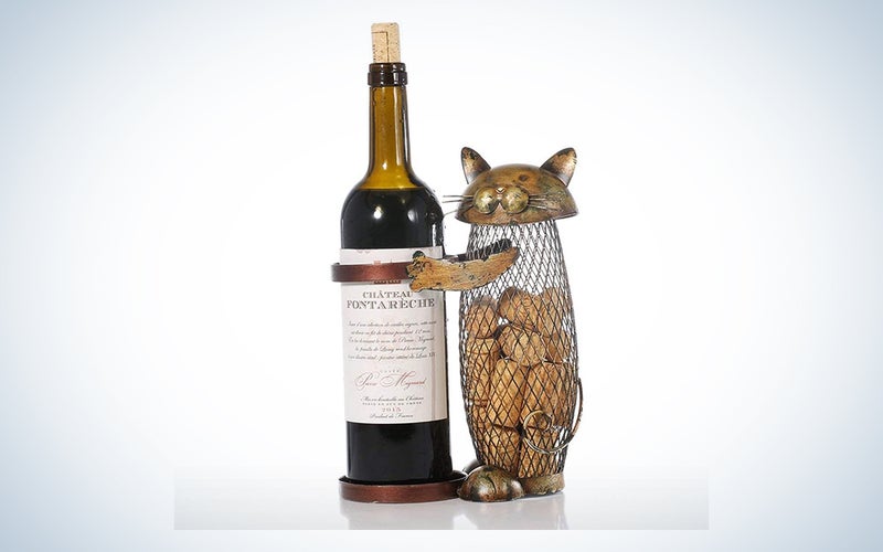 A cat wine holder with cork storage on a blue and white background