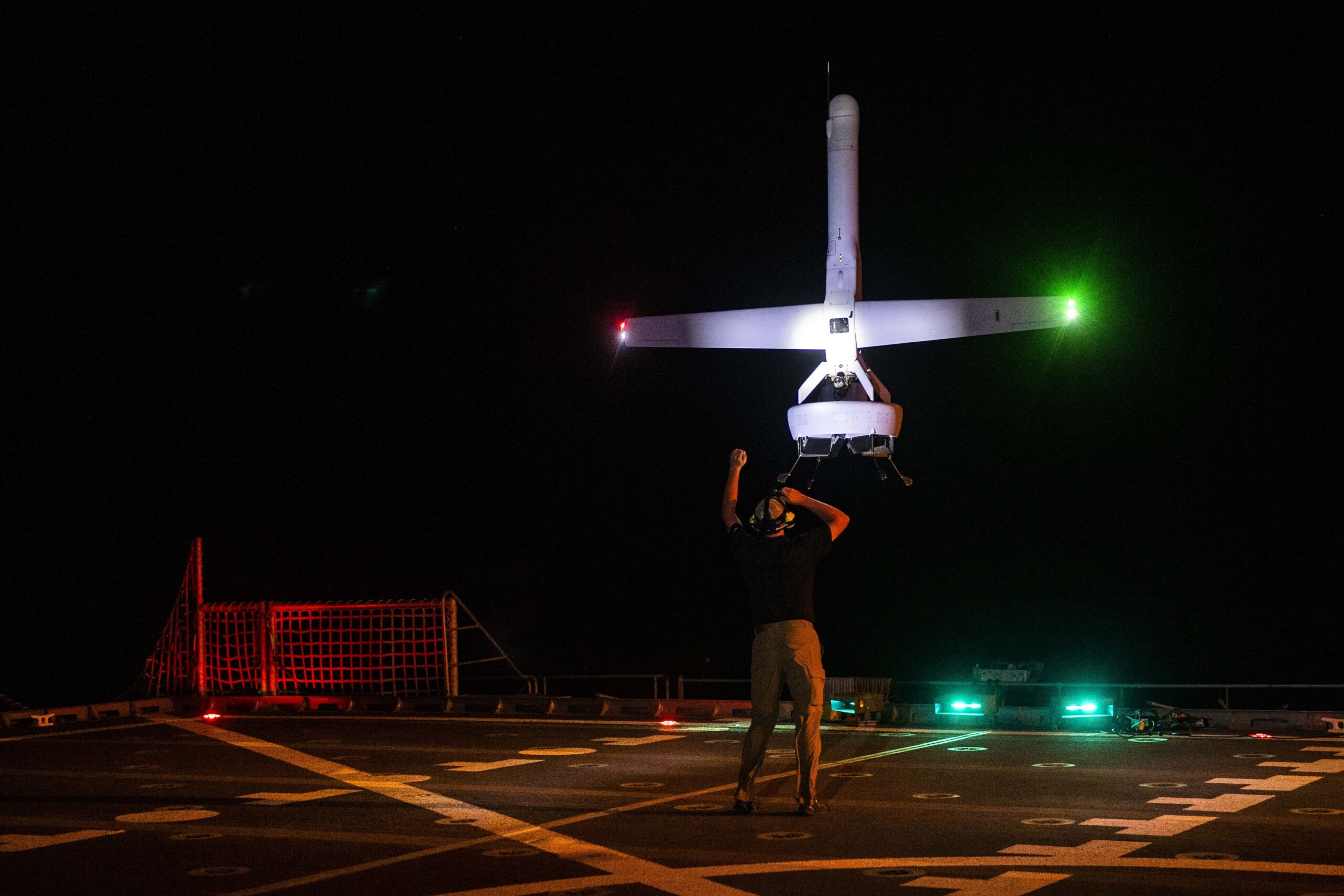 A VBAT vertical take-off and landing (VTOL) unmanned aerial system (UAS) prepares to land on the flight deck of the Military Sealift Command expeditionary fast transport vessel USNS Spearhead