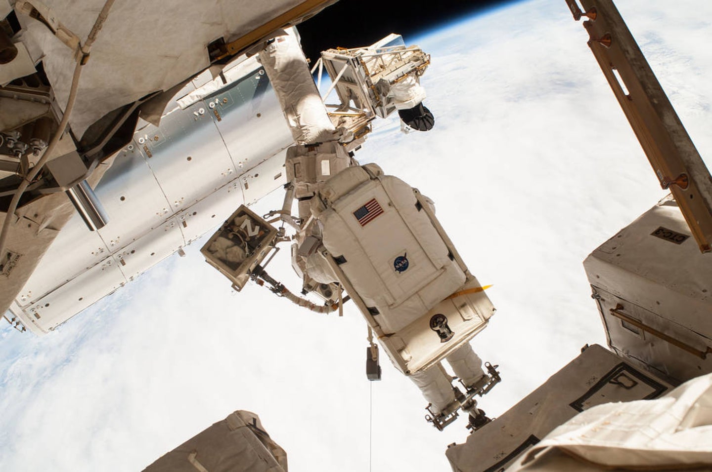 NASA astronaut Terry Virts on a spacewalk as the Earth's surface passes by in the background on February 25, 2015. 