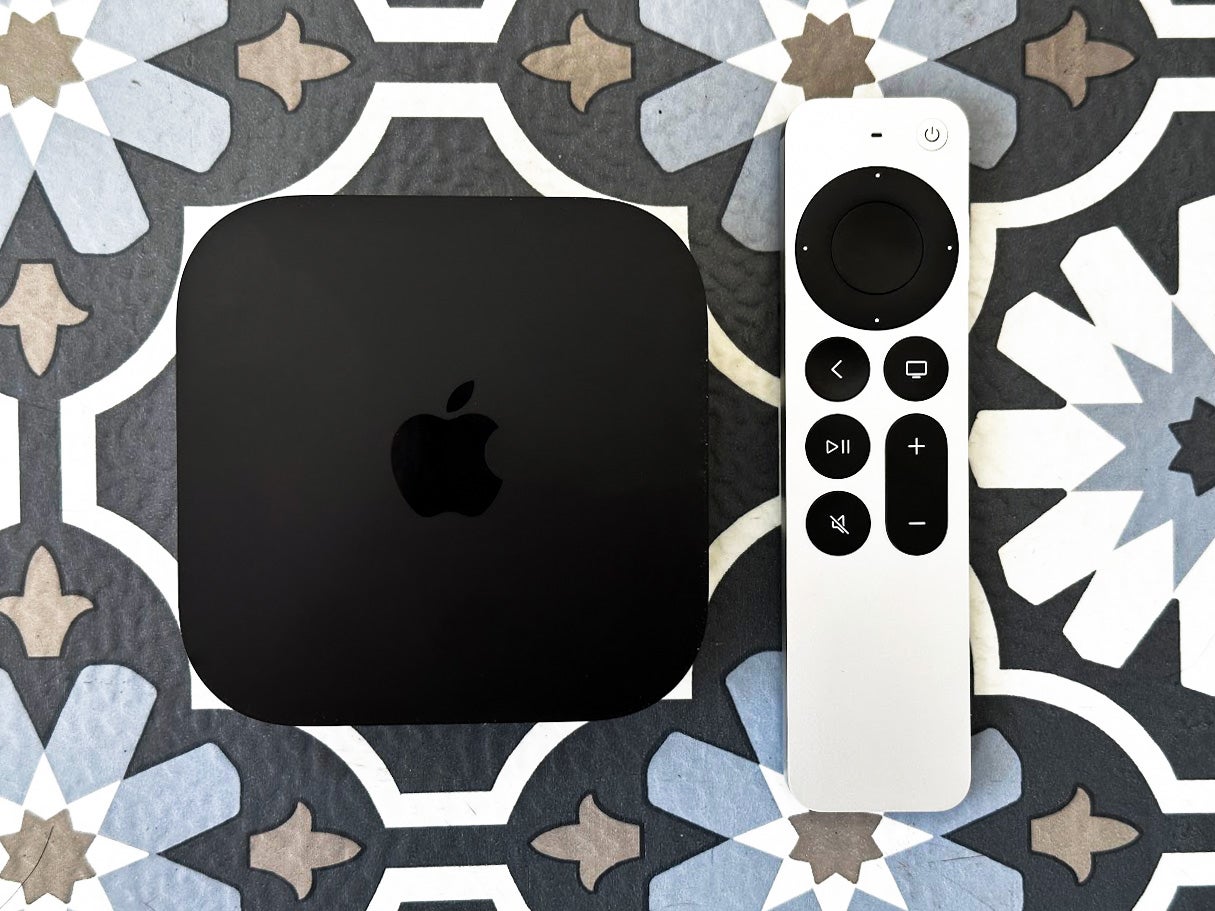 Apple TV 4K with the remote on a patterned backdrop