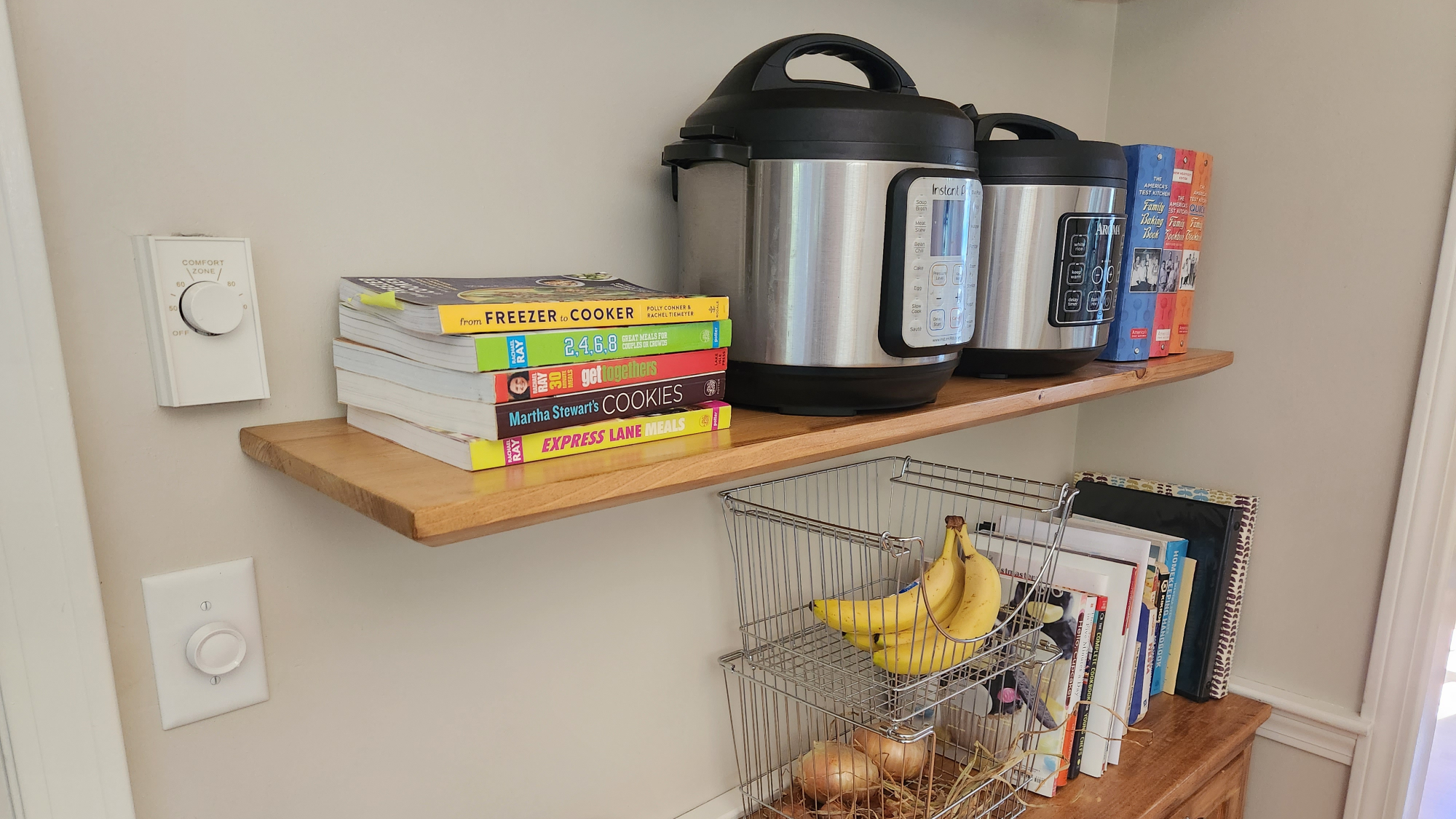 A DIY floating shelf in a home with an Instant Pot and some books on it.