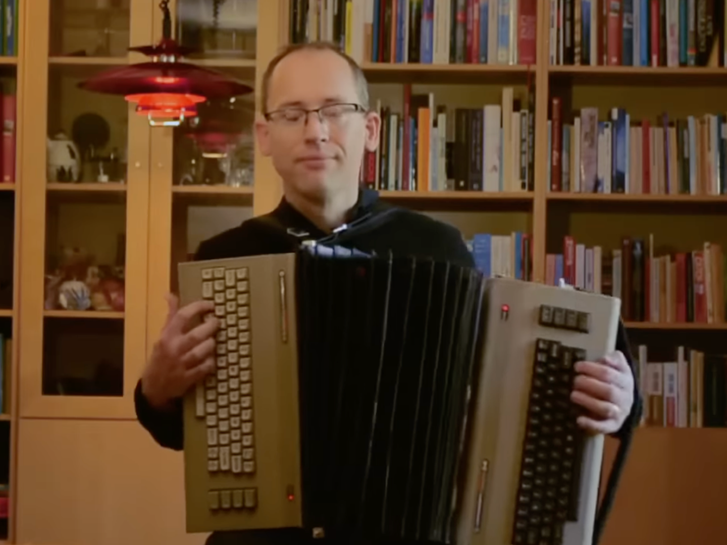 Swedish engineer Linus Åkesson playing homemade accordion made of two Commodore 64 computers and floppy disks