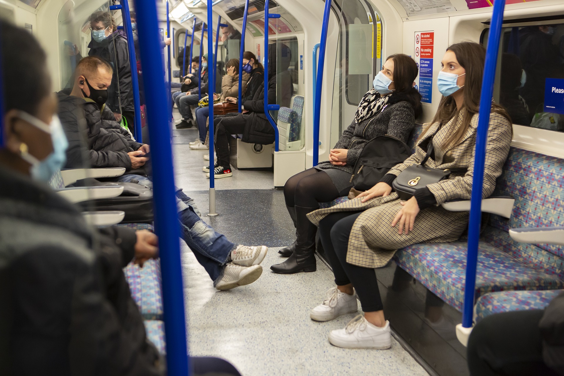 Passengers on a train wear face masks.