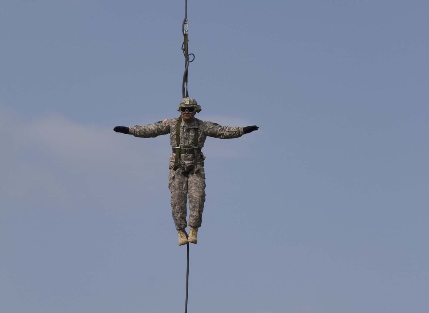 A soldier hanging from a helicopter in 2014 in Kosovo.