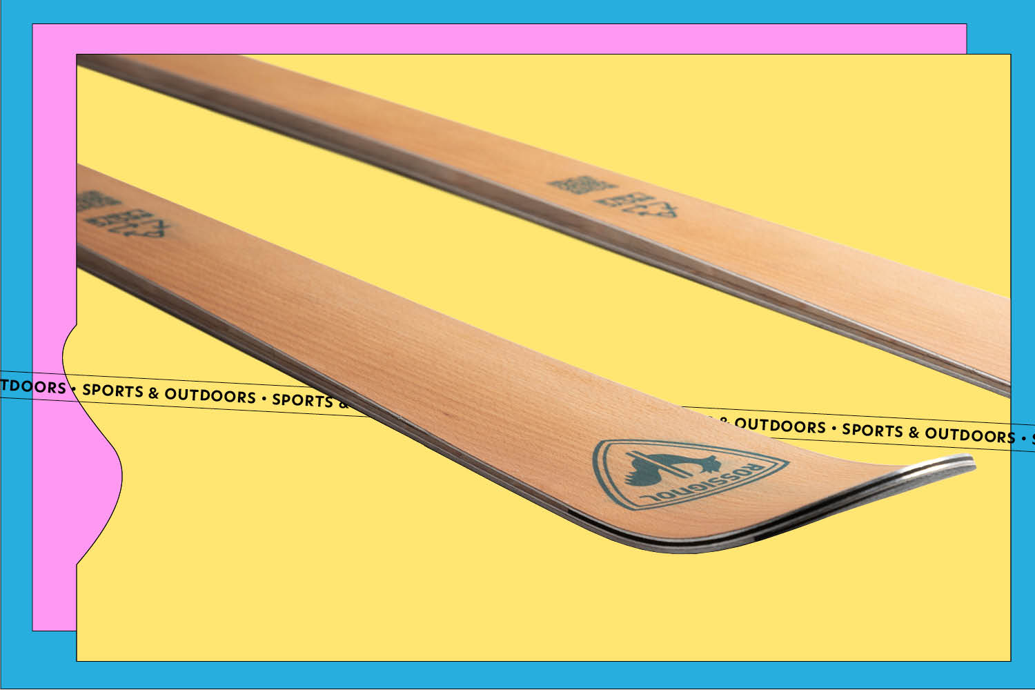 A pair of Rossignol Essential skis on a yellow, blue, and pink background