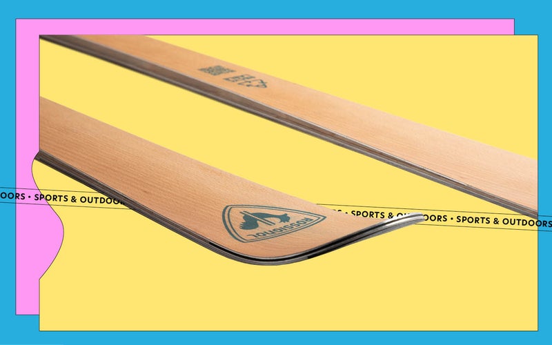 A Rossingnol Essential ski on a yellow, pink, and blue background
