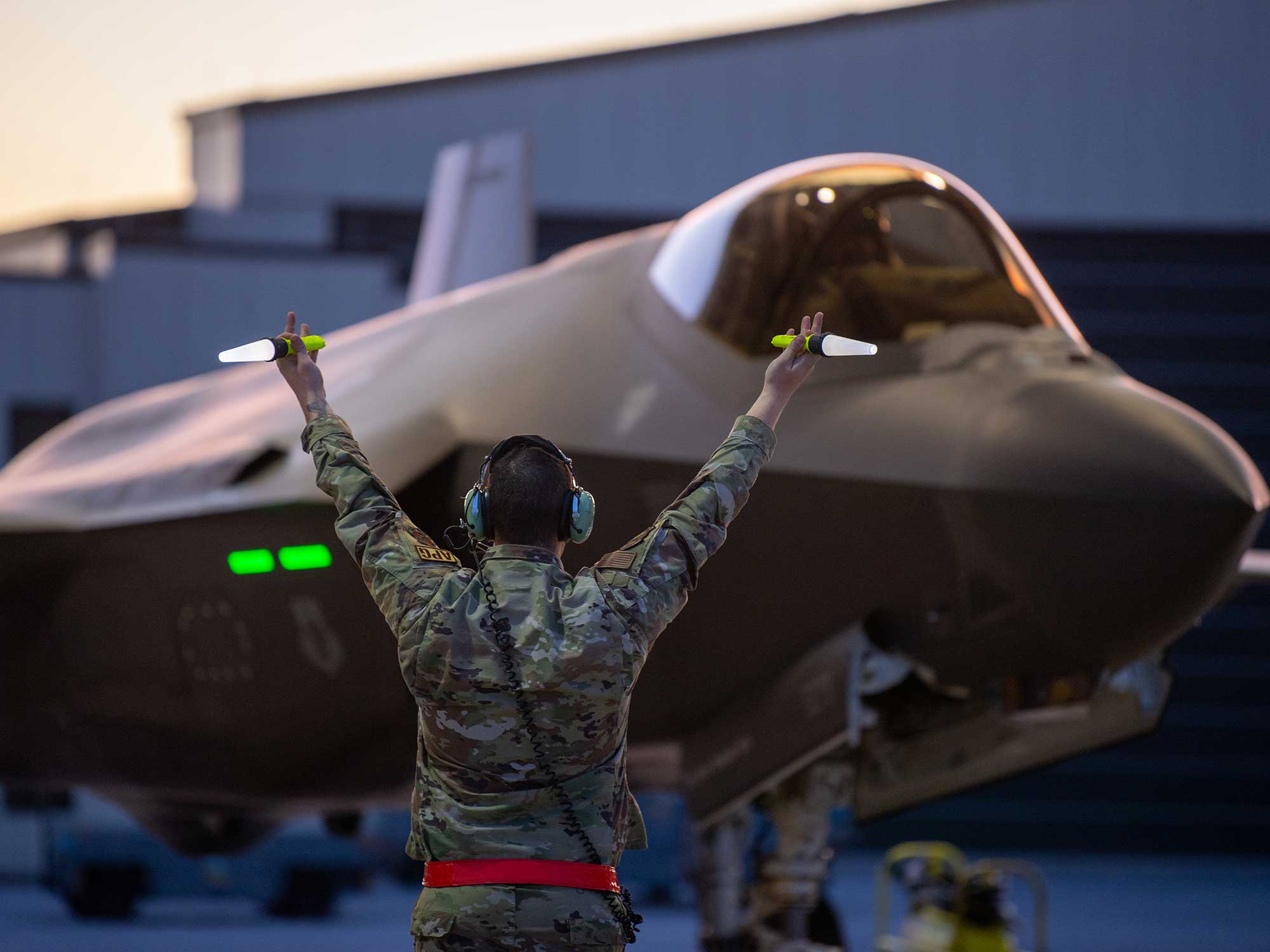 A crew chief assigned to the 158th Fighter Wing, taxis an F-35A Lightning II fifth generation aircraft assigned to the wing at the Vermont Air National Guard Base, South Burlington, Vermont, May 2, 2022.