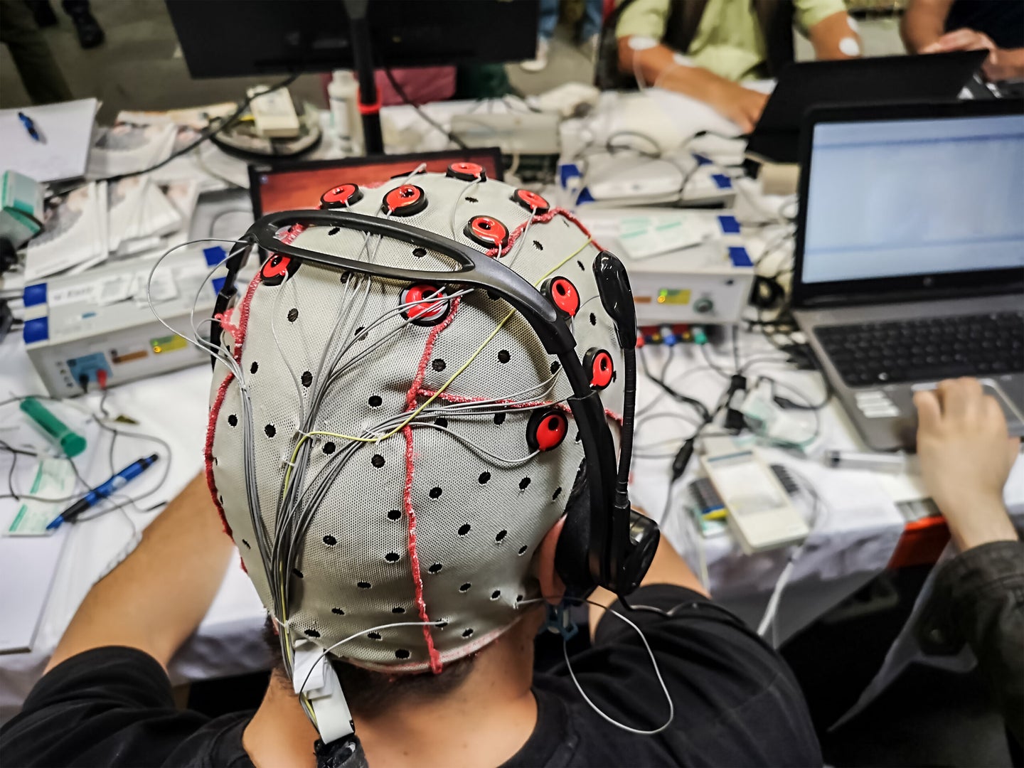 Brain-computer interfaces can take different forms, such as an EEG cap or implant in the brain.