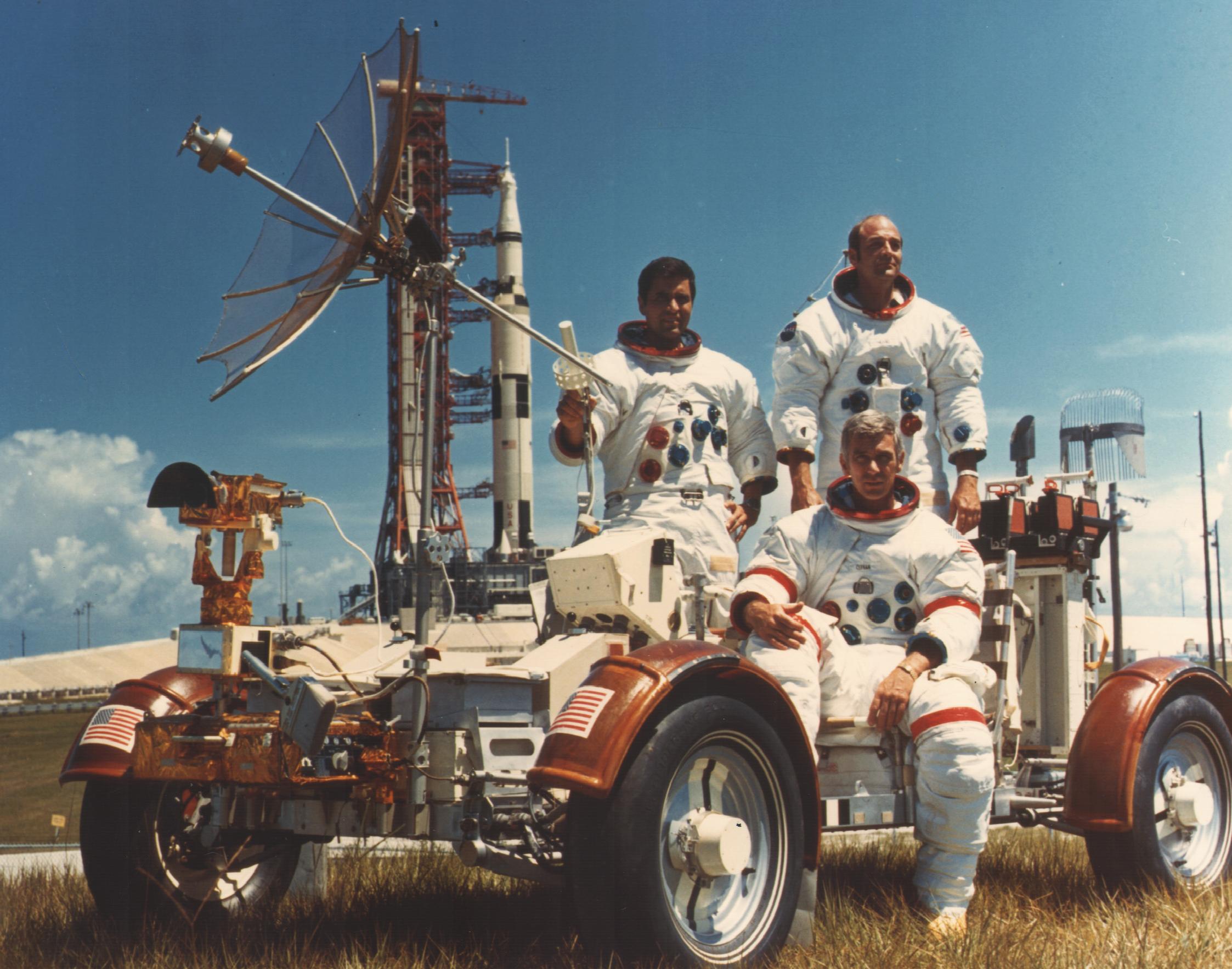 The crew of Apollo 17, Harrison H. Schmitt, Eugene A. Cernan, and Ron Evans, pose with a Lunar Roving Vehicle trainer.