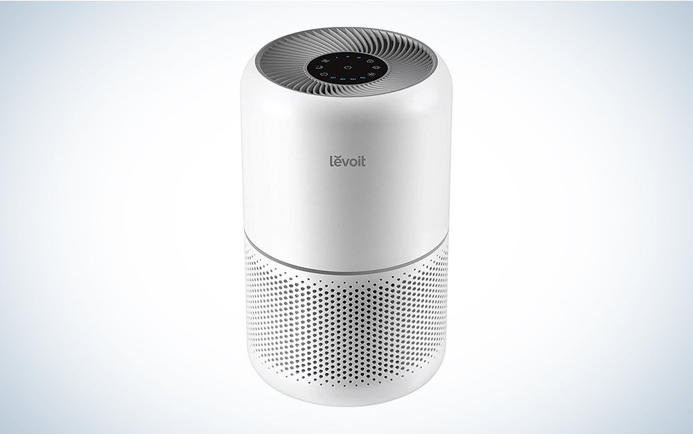 A Levoit Core 300 Air Purifier on a blue and white background