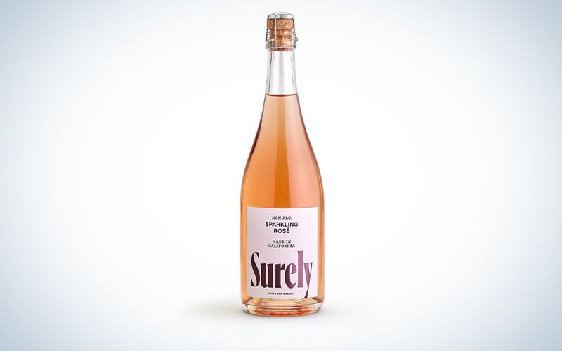 A bottle of Surely NA wine on a blue and white background