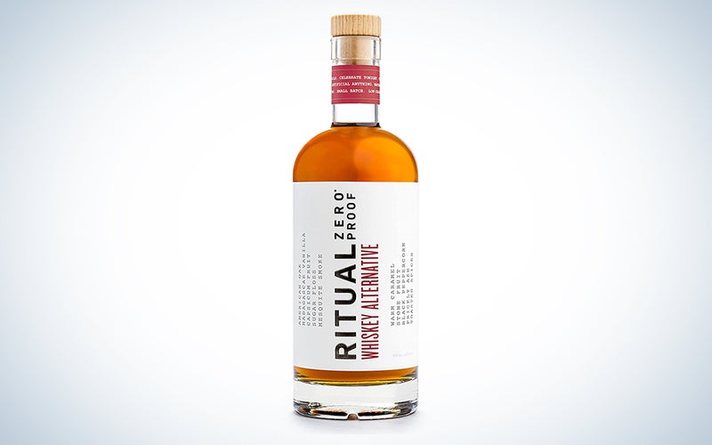 A bottle of Ritual whiskey alternative on a blue and white background