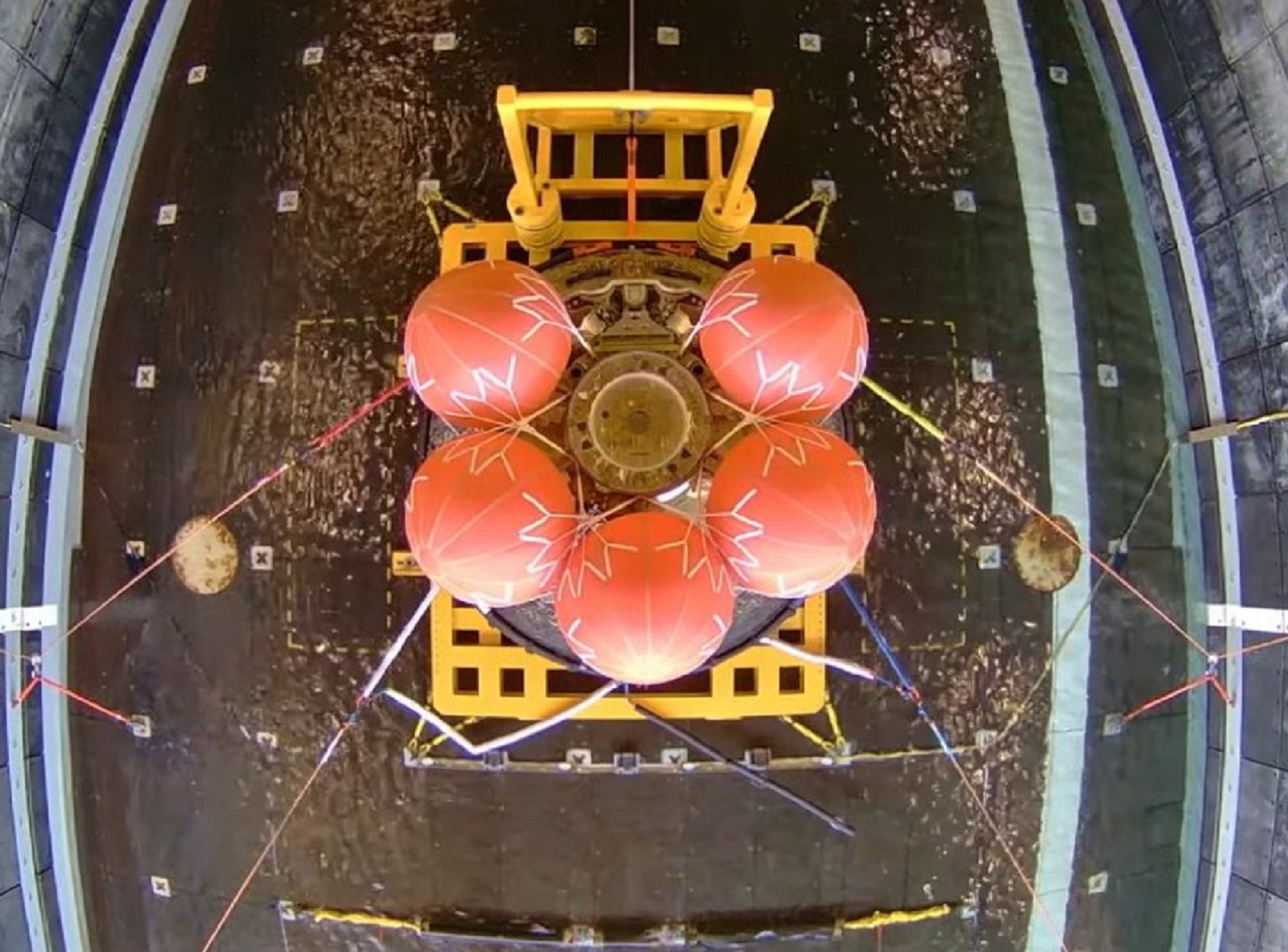 NASA Orion space vehicle on Navy ship with parachutes deployed