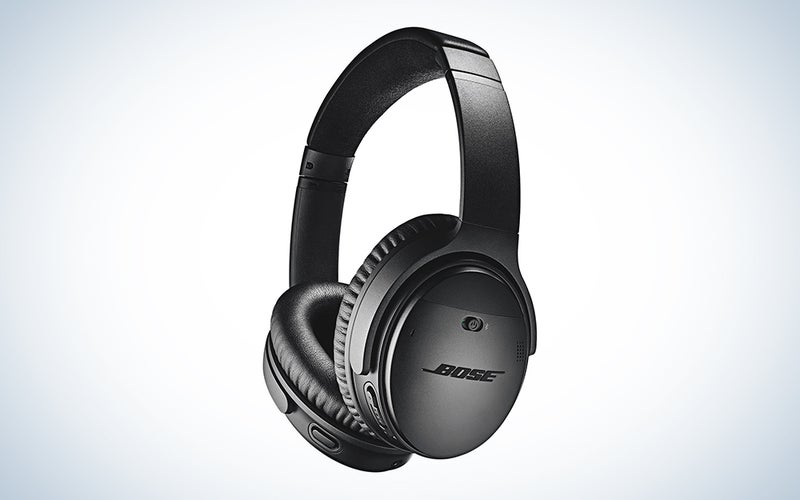 A pair of Bose quiet comfort headphones in black on a background of blue and white