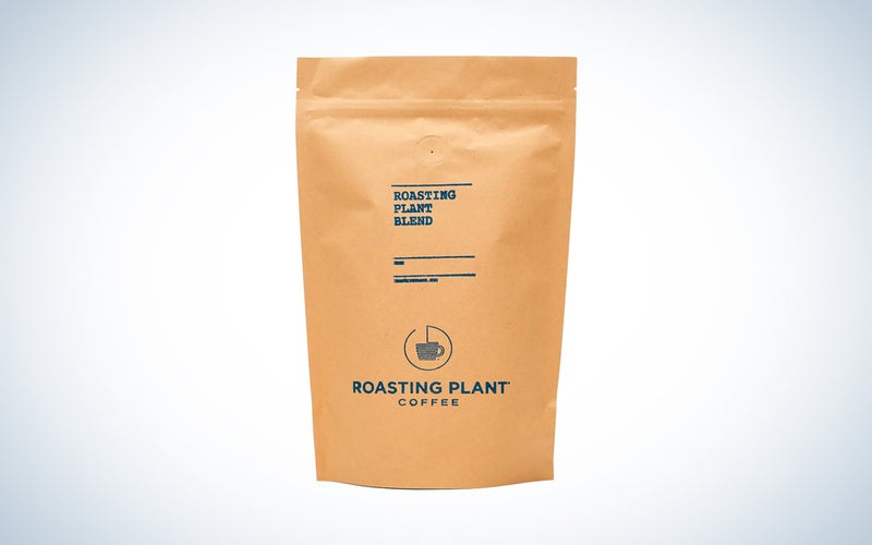 A bag of Roasting Plant coffee on a blue and white background