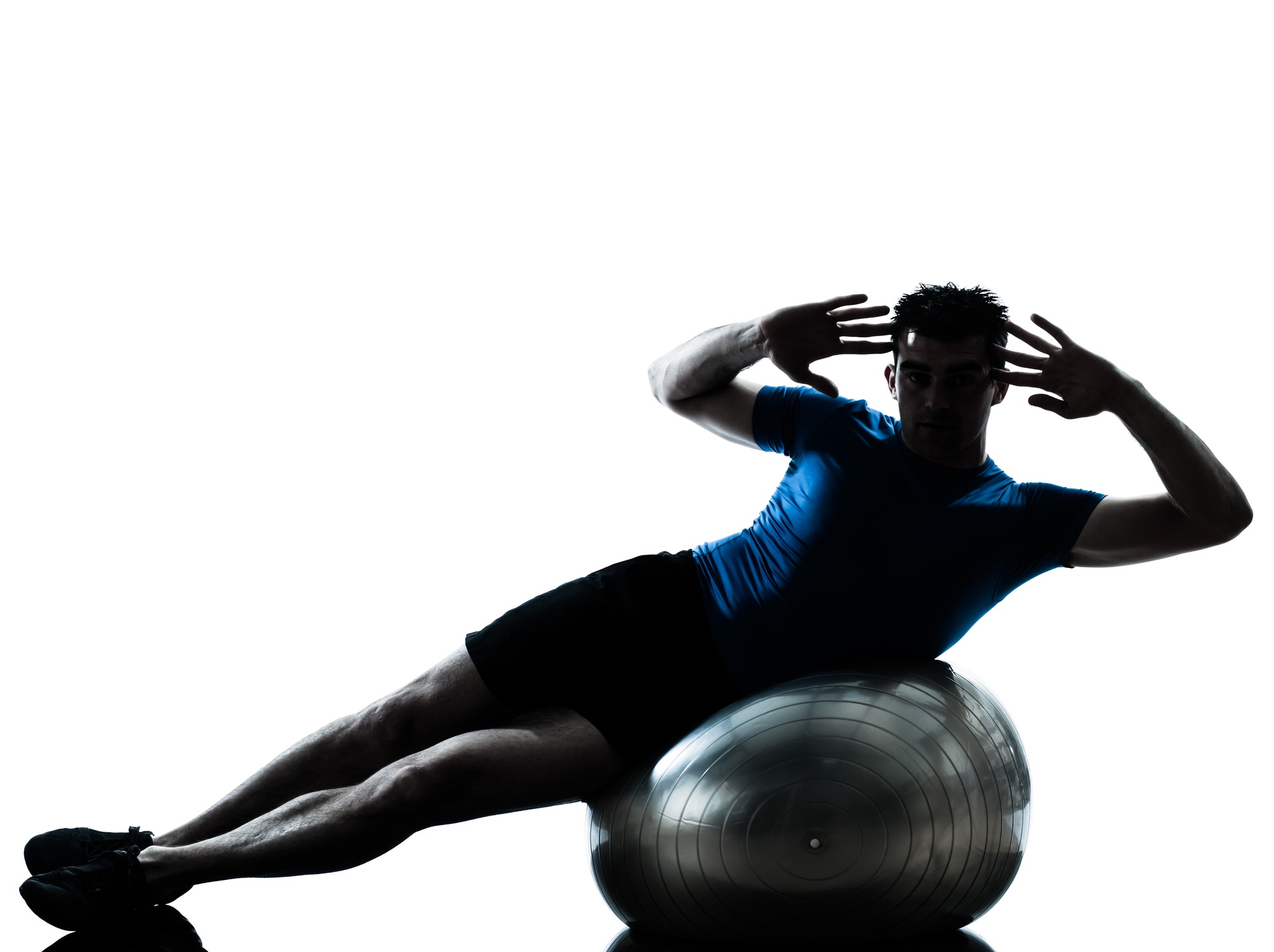 Person in blue shirt doing crunches on an exercise ball during a Pilates workout