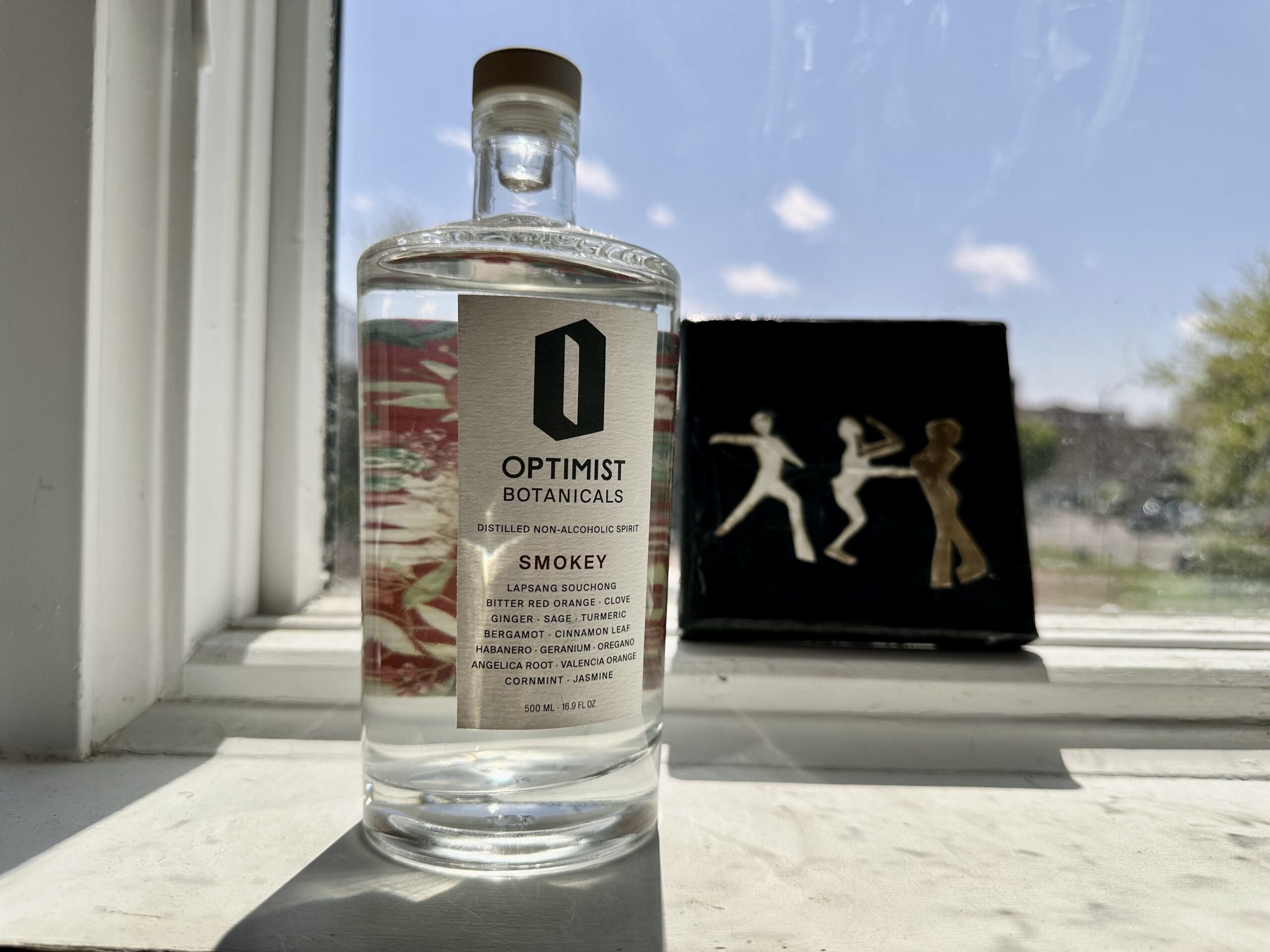 optimist non alcoholic tequila alternative in front of a window