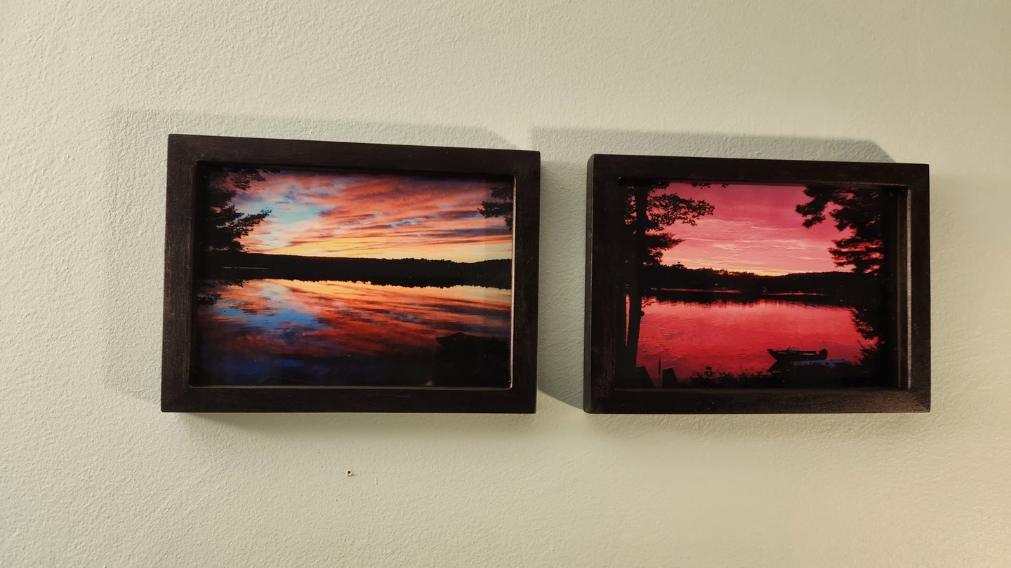 Two DIY picture frames next to each other on a beige wall, with sunset photos inside them.